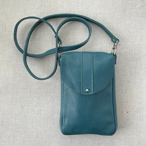 Dakota teal leather crossbody bag with button stud closure and back phone pocket handmade by Marge & Rudy in Charotte, NC