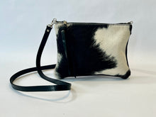 Load image into Gallery viewer, Small cowhide crossbody bag | convertible clutch in black and white hair on hide, handmade in Charlotte NC by Marge and Rudy