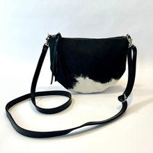 Load image into Gallery viewer, Handcrafted leather cowhide crossbody bag with zippered closure in black and white spotted hair on hide