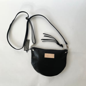 Handcrafted leather crossbody bag with zippered closure in black leather , back view