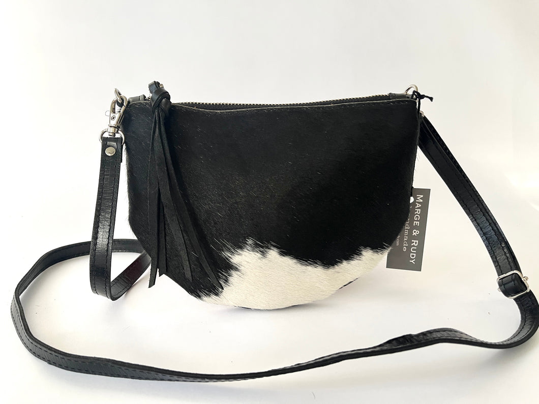 Handcrafted leather hair on hide crossbody bag in black and white spotted cowhide