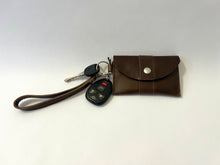 Load image into Gallery viewer, Handcrafted genuine leather keychain wallet with wristlet strap in brown shown brown  leather with silver snap with keys attached .