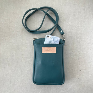 Handmade leather crossbody bag with back phone pocket in teal leather made to order in Charlotte NC by Marge and Rudy